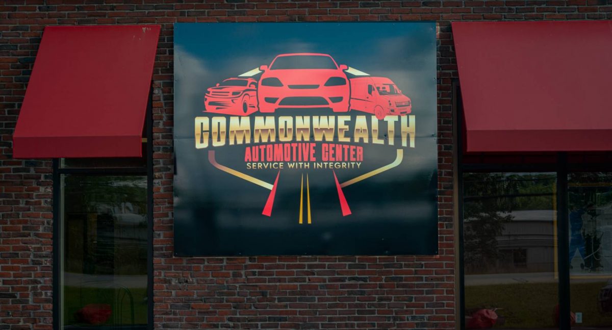 A sign for commonwealth automotive center on the side of a building.