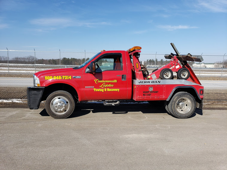 A red tow truck parked in the parking lot.
