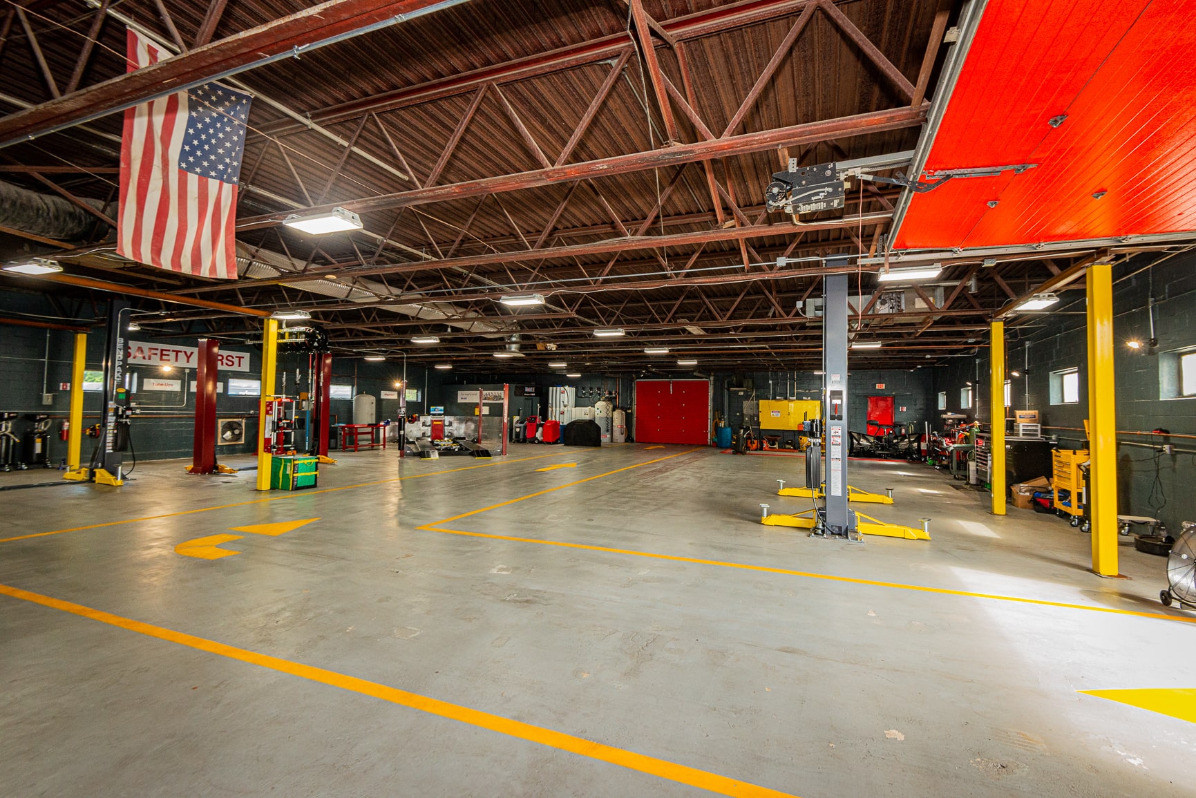 A large garage with many cars parked in it.