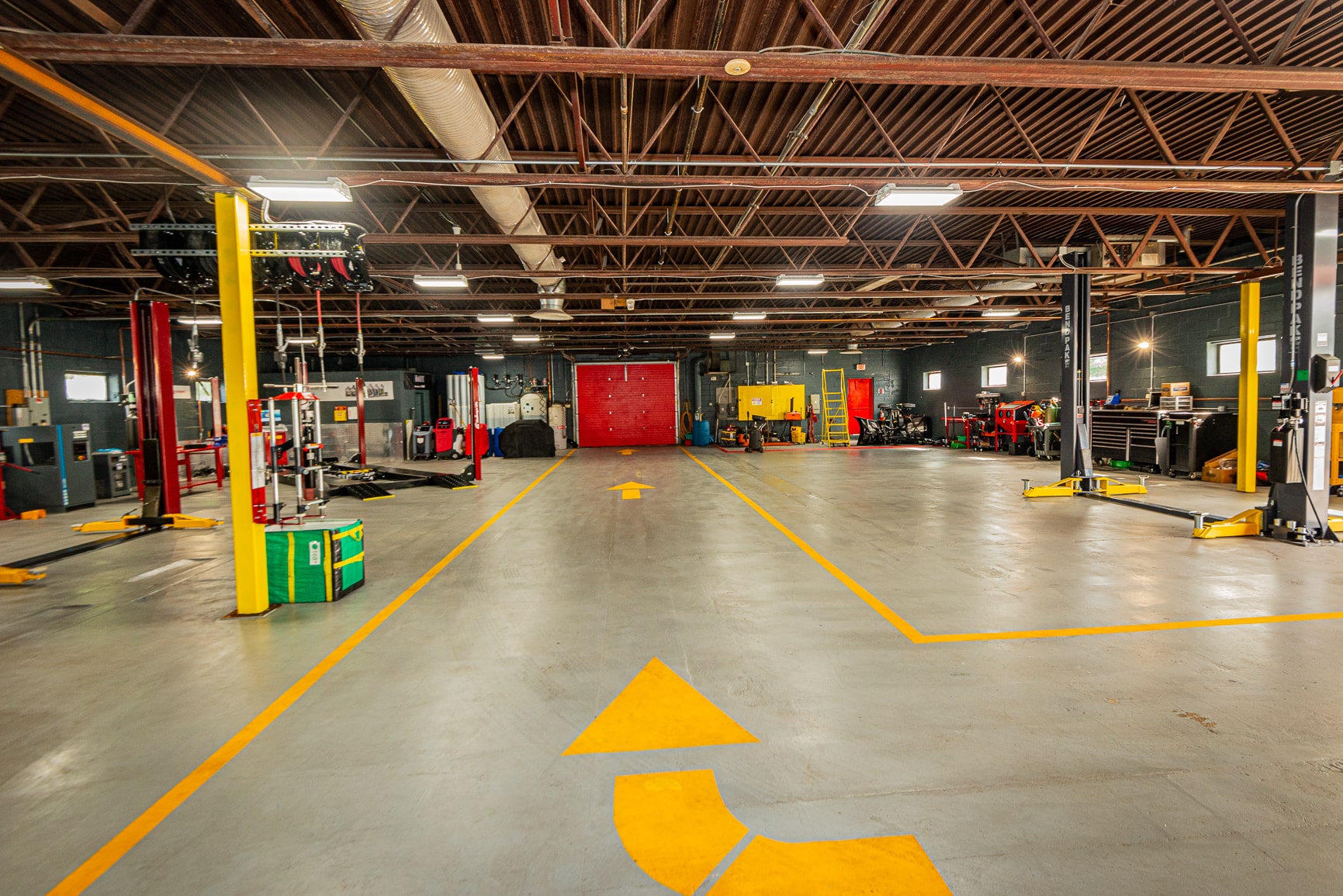 A large warehouse with yellow markings on the floor.