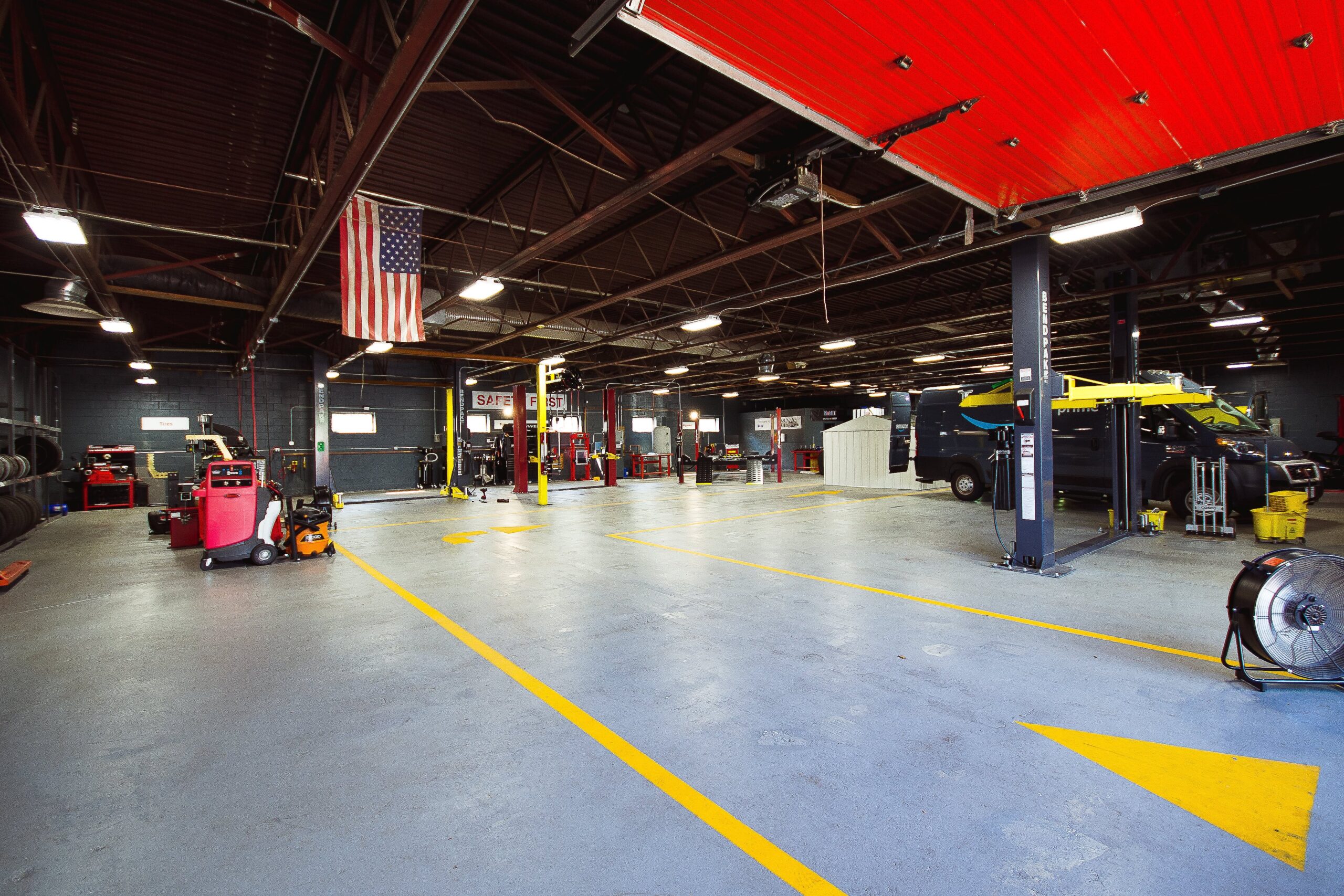 A large garage with many cars parked in it.