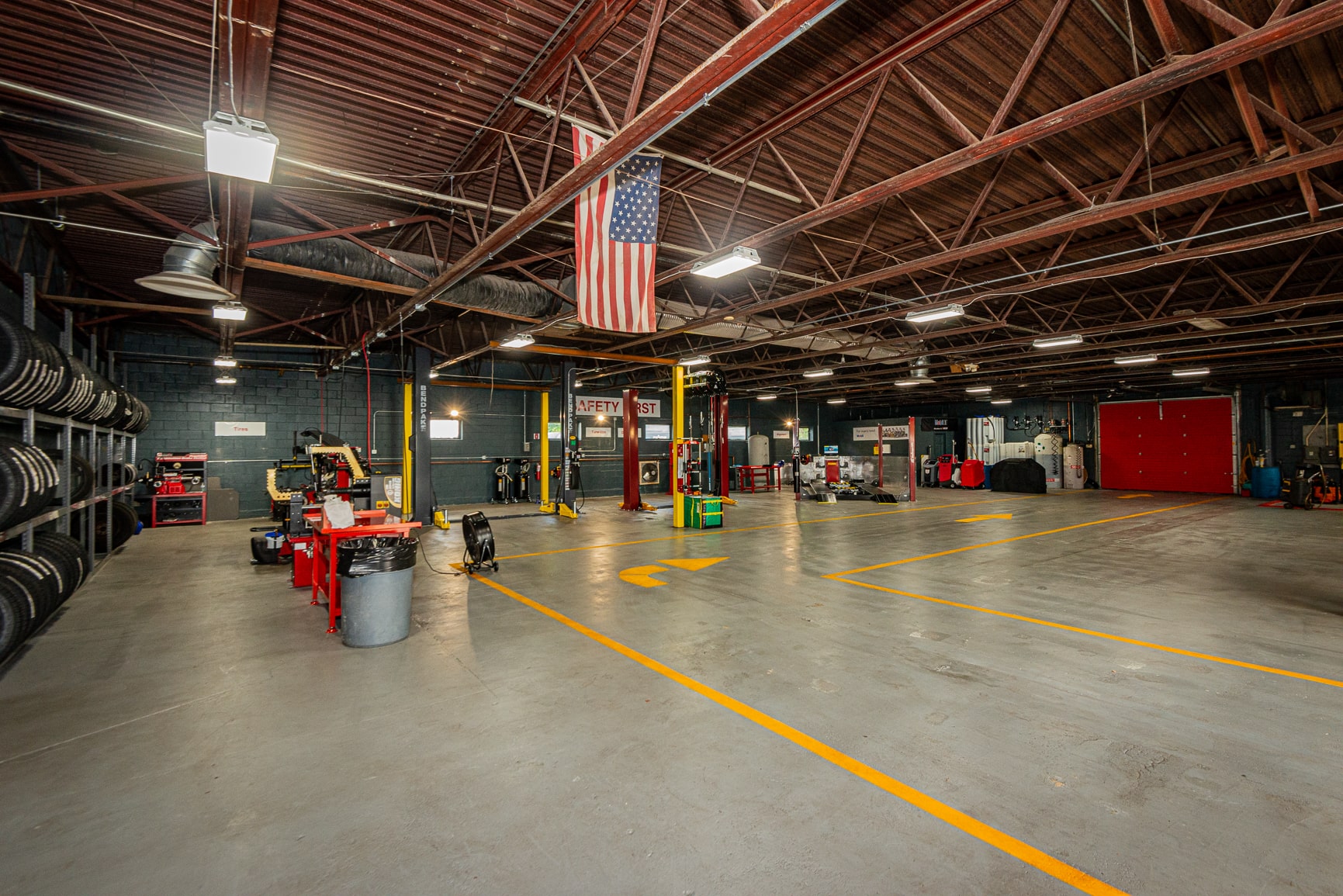 A large garage with many cars in it