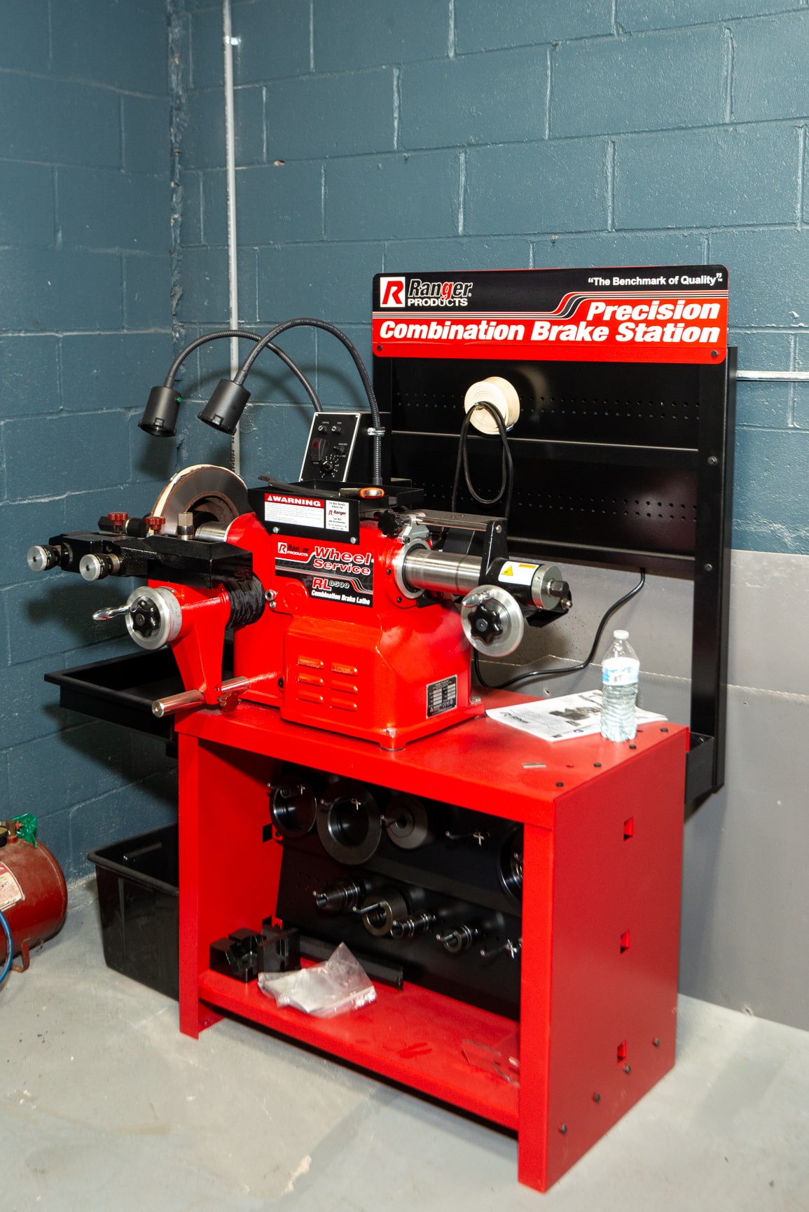 A red machine with various tools on it.