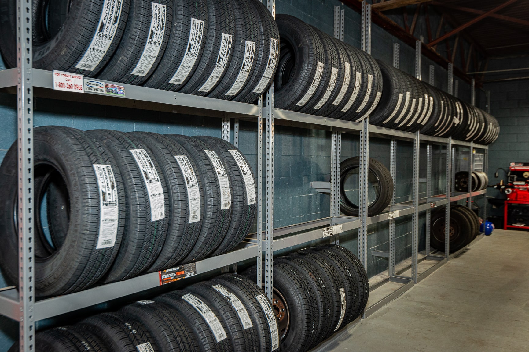 A wall of tires in a warehouse.